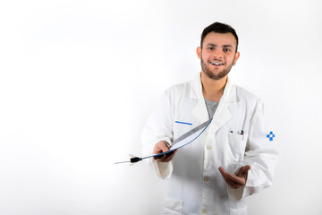 Smiling and willing Young male doctor with beard medical report in hands isolated on white...