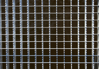 Dirty urban welded metal grid frame on black background