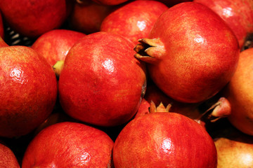 Fototapeta na wymiar Many bright red ripe pomegranate fruits at market place