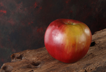 Fototapeta na wymiar artificial red apple on wooden table
