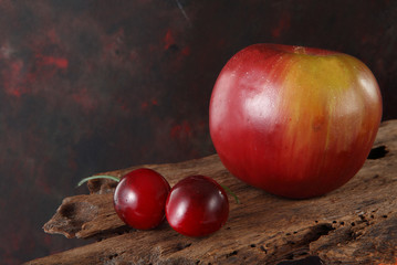 Fototapeta na wymiar artificial apple and cherry with background