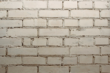 Obraz premium Dirty old white exterior brick wall background