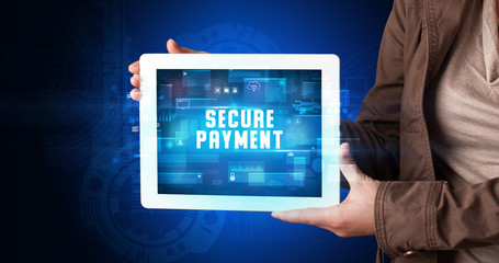 Young business person working on tablet and shows the digital sign: SECURE PAYMENT