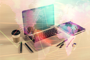 Stock market chart with globe hologram and desktop office computer background. Multi exposure....