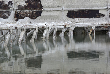reflected rust iron calcium and magnesium deposits on industrial strucutre