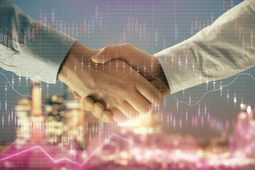 Double exposure of financial chart on cityscape background with two businessmen handshake. Concept of financial analysis and investment opportunities