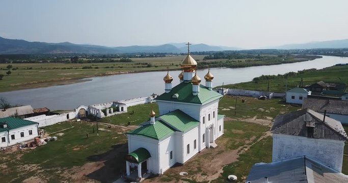 Holy Trinity Selenginsky Monastery flight above helicopter drone. Near Ulan-Ude best Russian nature panorama open space. Forward move cinematic. Sunny day.