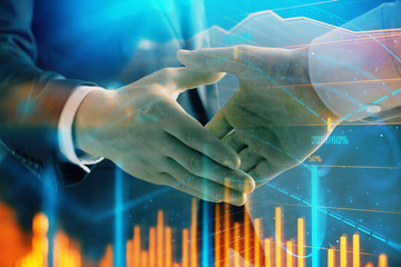 Multi exposure of forex graph on abstract background with two businessmen handshake. Concept of success on stock market