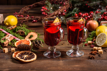 Christmas hot mulled wine with cinnamon cardamom and anise on wooden background