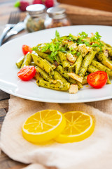 Pasta with pesto sauce and nuts on a the table