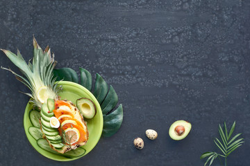 Pineapple boat on dark background, text space