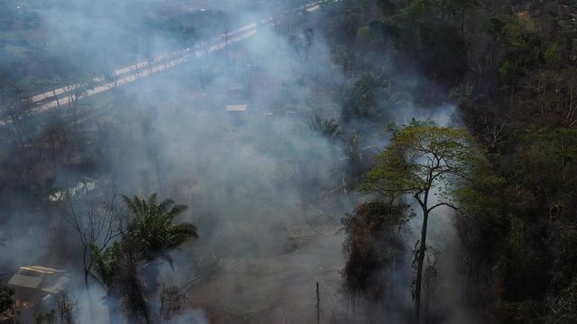 Aerial shot flying towards clouds of smoke from the Amazon rainforest