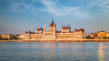 Fototapeta premium The Hungarian Parliament Building, a notable landmark of Hungary in Budapest. View of the main facade above the Danube river at a sunset.