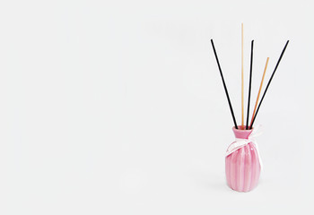 wooden sticks for aromatherapy in a ceramic pink vase