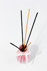 wooden sticks for aromatherapy in a ceramic pink vase