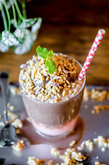 Chocolate and strawberry smoothie with rice krispie treats topping.