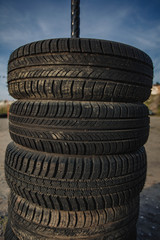 Obraz premium car rubber tires lying on top of each other.