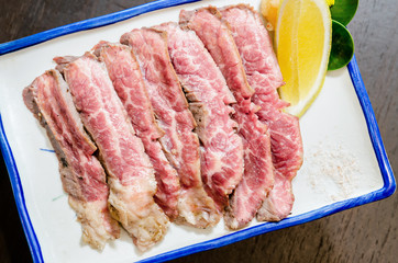 Sliced grilled Strip Loin rare degree of ripeness beef steak.