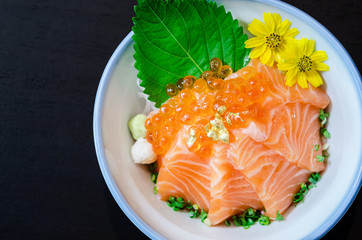 Salmon sashimi with salmon's egg (Ikura) in bowl.