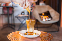 Iced coffee with milk in tall glasses on the table.