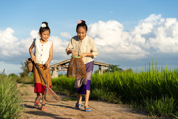 Asian children in rice fields with countryside background