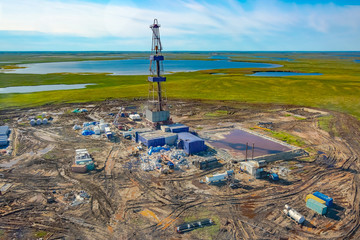 Drilling rig and equipment at an oil field in the northern tundra. Top view from a helicopter....
