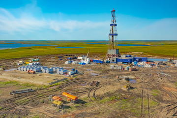 Drilling rig and equipment at an oil field in the northern tundra. Top view from a helicopter....