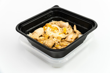 Top view Ready easy meal Oyakodon chicken with rice in black plastic bowl isolated on white background 