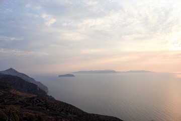 Greece the island of Sikinos. A gentle sunset over the neighbouring island of Folegandros. A warm and atmospheric summers evening.