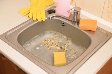 Close up on dirty clogging kitchen sink drain with food particles