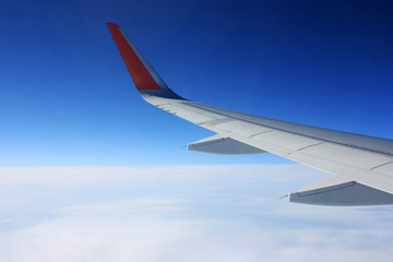 Airplane wing in blue sky