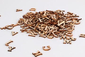 heap of small wooden letters in the white studio