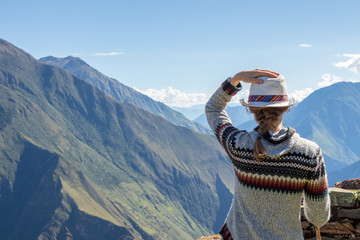 Young free woman travel alone in Andes mountains in Peru. Landscape with solo female tourist,...