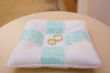 Gold wedding rings on stand for rings