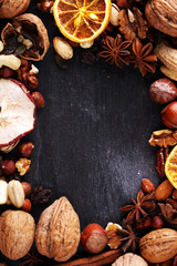 Composition with dried fruits and assorted healthy nuts on rustic background for christmas