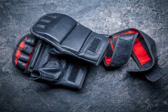 Mixed martial arts black gloves on gray background