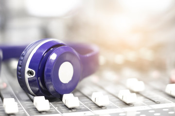 Naklejka na ściany i meble Headphones on the audio mixer in the control room.