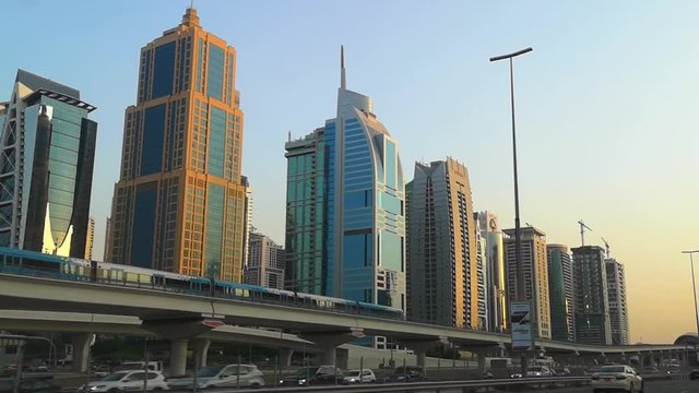 View of Dubai city - Dubai Metro train on Sheikh Zayed road - Dubai landmark towers and skyscrapers