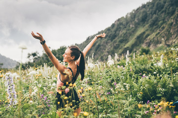 Running woman on top of mountain happy and celebrating success. Woman n the nature mountain...