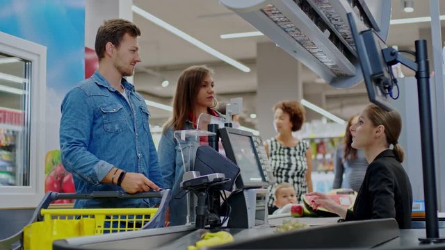 Man paying with a smartphone in a grocery store