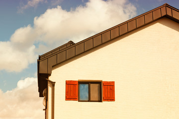 House of wooden fairy-tale window with copy space at sunset.