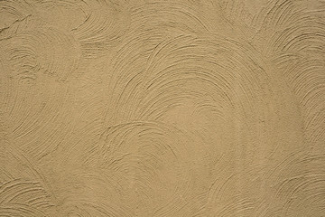 stylish beige background from decorative plaster on the wall made in the form of arcs, curved lines, waves for the original project of art design