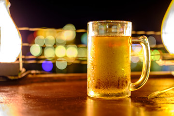 glass of beer and chips on wooden table