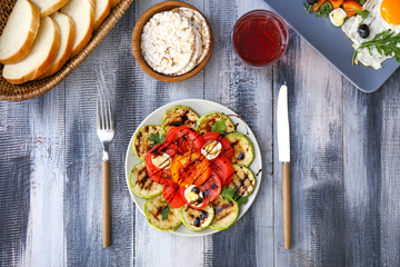 Plate with tasty vegetable salad on wooden table