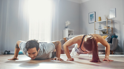 Shot of a Strong and Beautiful Athletic Fitness Couple in Workout Clothes Doing Push Up Exercises....