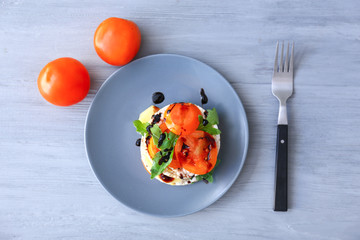 Plate with tasty fresh vegetables and crispbread on table
