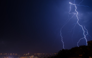 Naklejka premium Lightning strike in the city Kyiv.. Storm outside. Thunderstorm with lightning in the city. Moment lightning