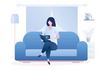 Caucasian woman is sitting on the couch and read book, living room interior