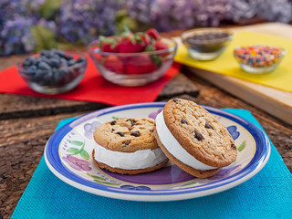 ice cream sandwiches on plate with assorted fruit in background 