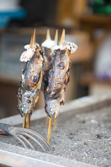 Charcoal grilled Ayu fish with salt. Traditional Japanese street food at Kegon waterfall in Nikko, Japan.